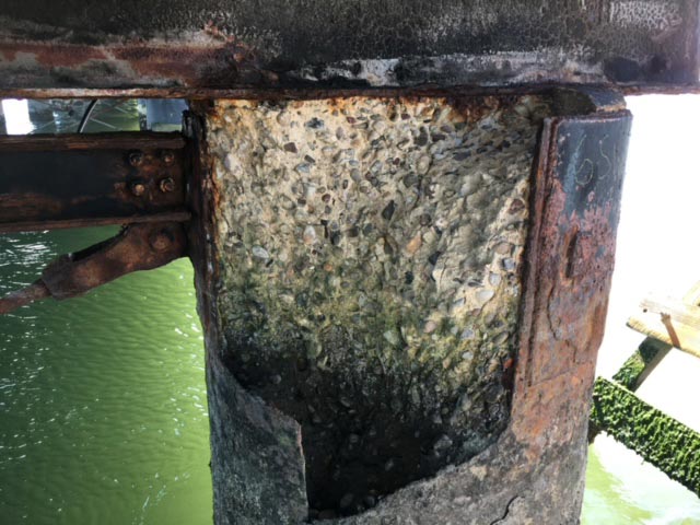 IMG_0045 Close-up of a severely corroded steel beam that needs marine pier repair services for structural reinforcement.