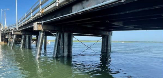 Bridge pilings in water for a pier steel casings rehabilitaton project by the team from Underwater Construction Corporation.