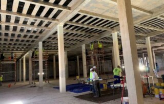View of the interior of the concrete water tank with skilled UCC engineers applying measures to correct the leakage.