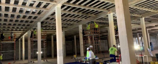 View of the interior of the concrete water tank with skilled UCC engineers applying measures to correct the leakage.