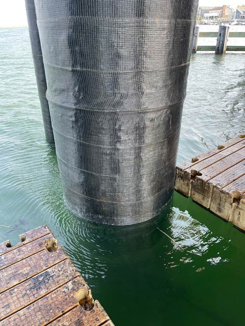 image002_2 Commercial pier piling reinforced with carbon fiber wrapping during marine pier repair by UCC.